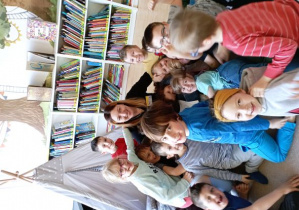 Dzieci pozują do zdjęcia z Panią Bibliotekarką